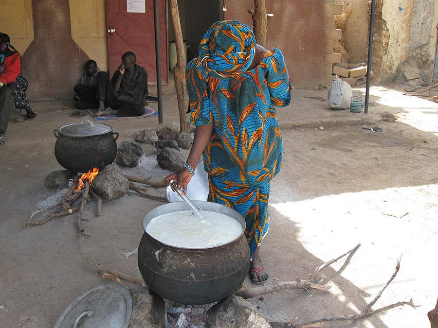 Image d’une femme faisant chauffer du lait.