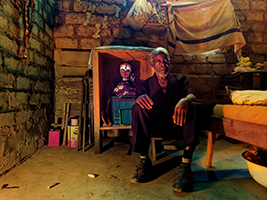 a man sitting in front of an artefact used in a Gabonese initiation ritual image small